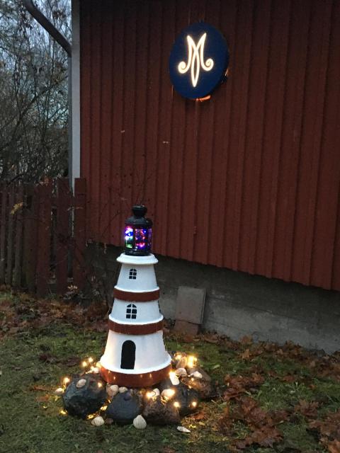 En liten fyr lyser utanför Brinkas stugan.